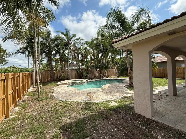 a backyard of a house with table and chairs
