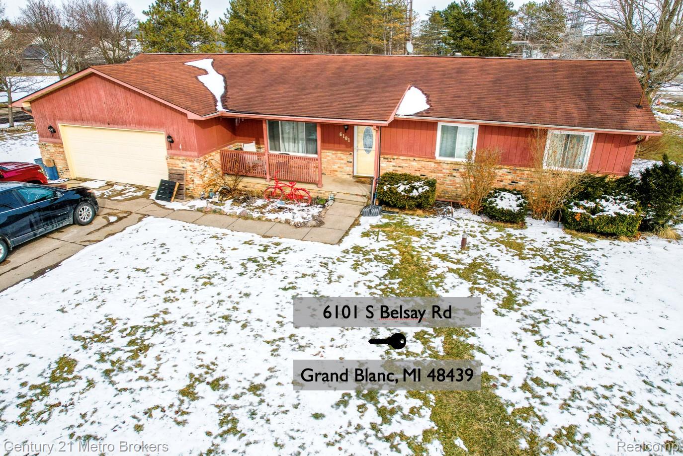 6101 Belsay Road Grand Blanc, MI 48439 - Photo 1 of 28 View of front facade featuring a porch, a garage, roof with shingles, and concrete driveway