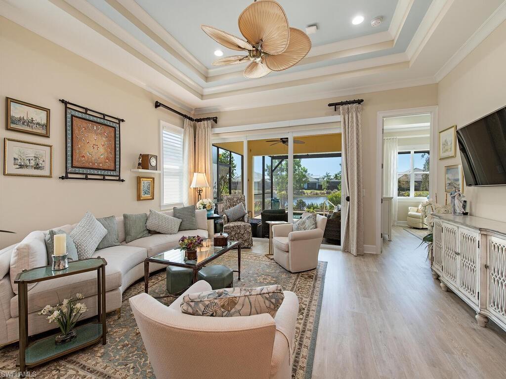 6822 Bequia Way Naples, FL 34113 - Photo 1 of 28 a living room with furniture and a flat screen tv