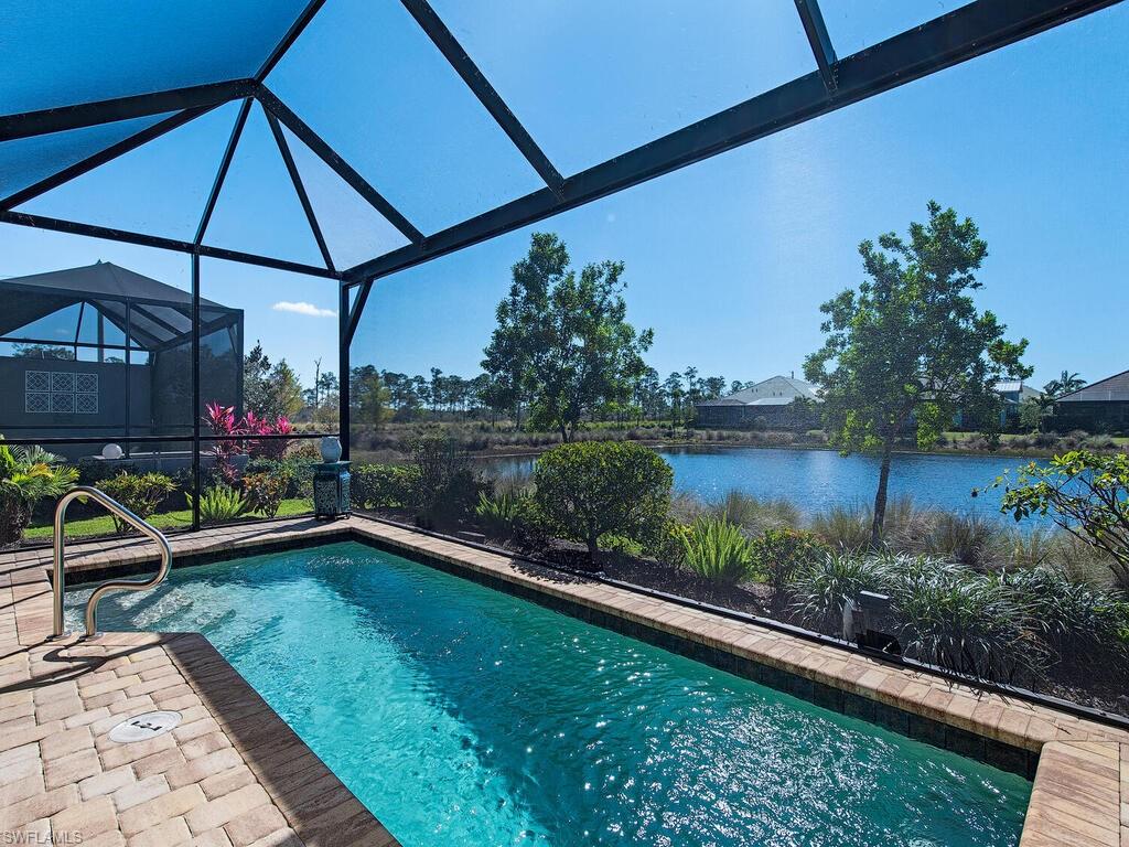 6822 Bequia Way Naples, FL 34113 - Photo 13 of 28 a view of a backyard with plants and lake view
