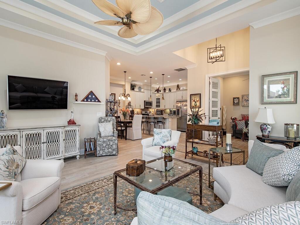 6822 Bequia Way Naples, FL 34113 - Photo 3 of 28 a living room with furniture and a flat screen tv