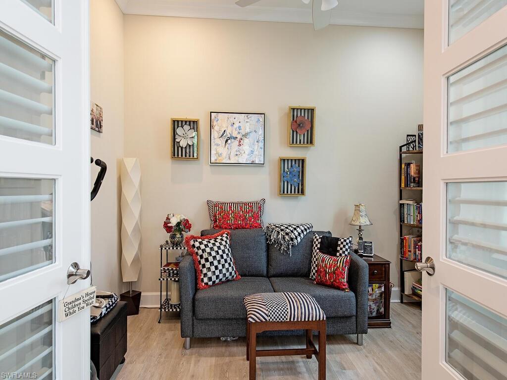 6822 Bequia Way Naples, FL 34113 - Photo 7 of 28 a living room with furniture and a window