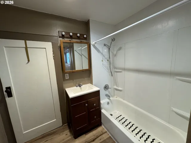 a bathroom with a bathtub a sink and a shower