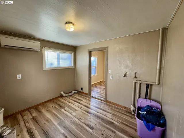 a view of a room with wooden floor and a window