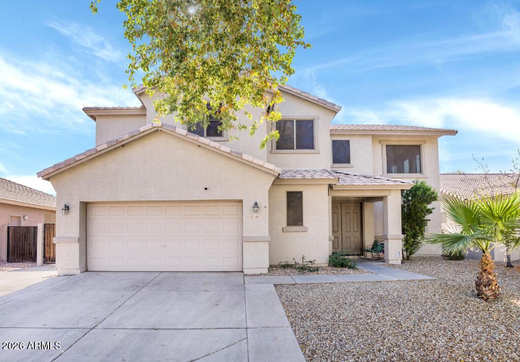 1813 East Beverly Road Phoenix, AZ 85042 - Photo 2 of 32 a front view of a house with a yard and garage