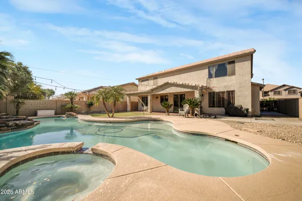 a view of a house with swimming pool and a yard