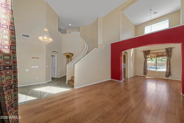 a view of a livingroom with wooden floor and stairs