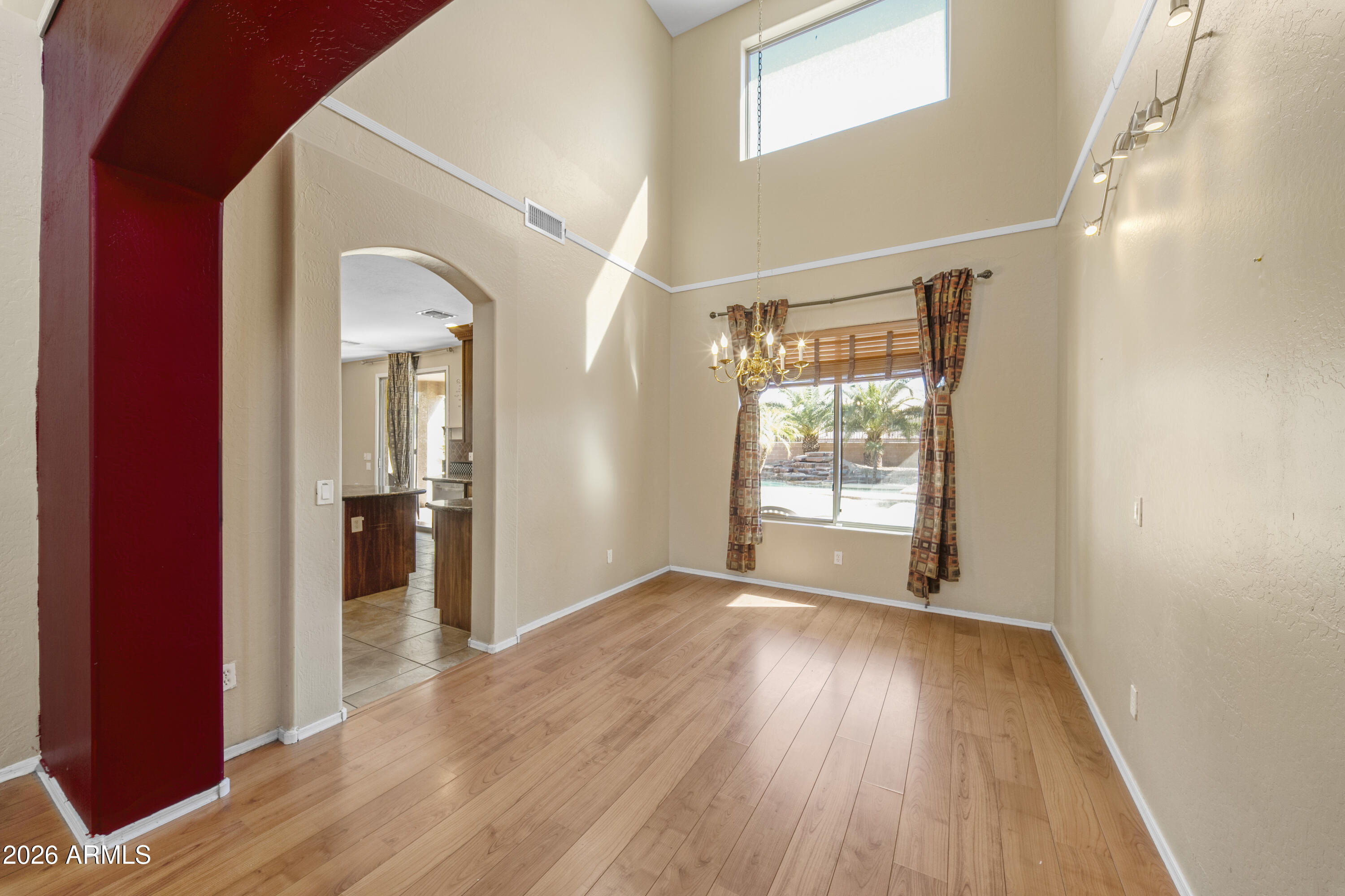 1813 East Beverly Road Phoenix, AZ 85042 - Photo 6 of 32 wooden floor in an empty room with a window