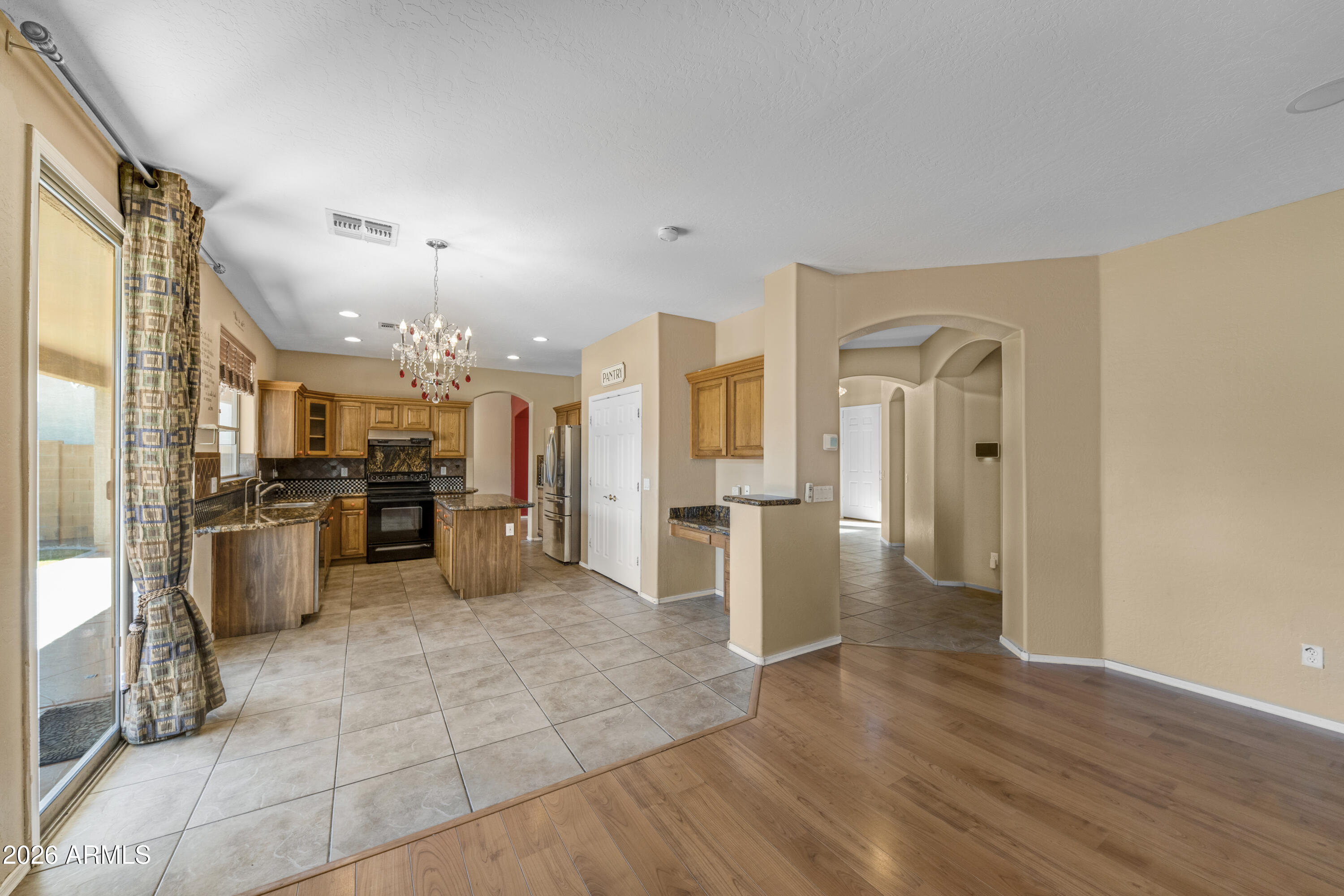 1813 East Beverly Road Phoenix, AZ 85042 - Photo 10 of 32 a view of a kitchen with refrigerator and wooden floor