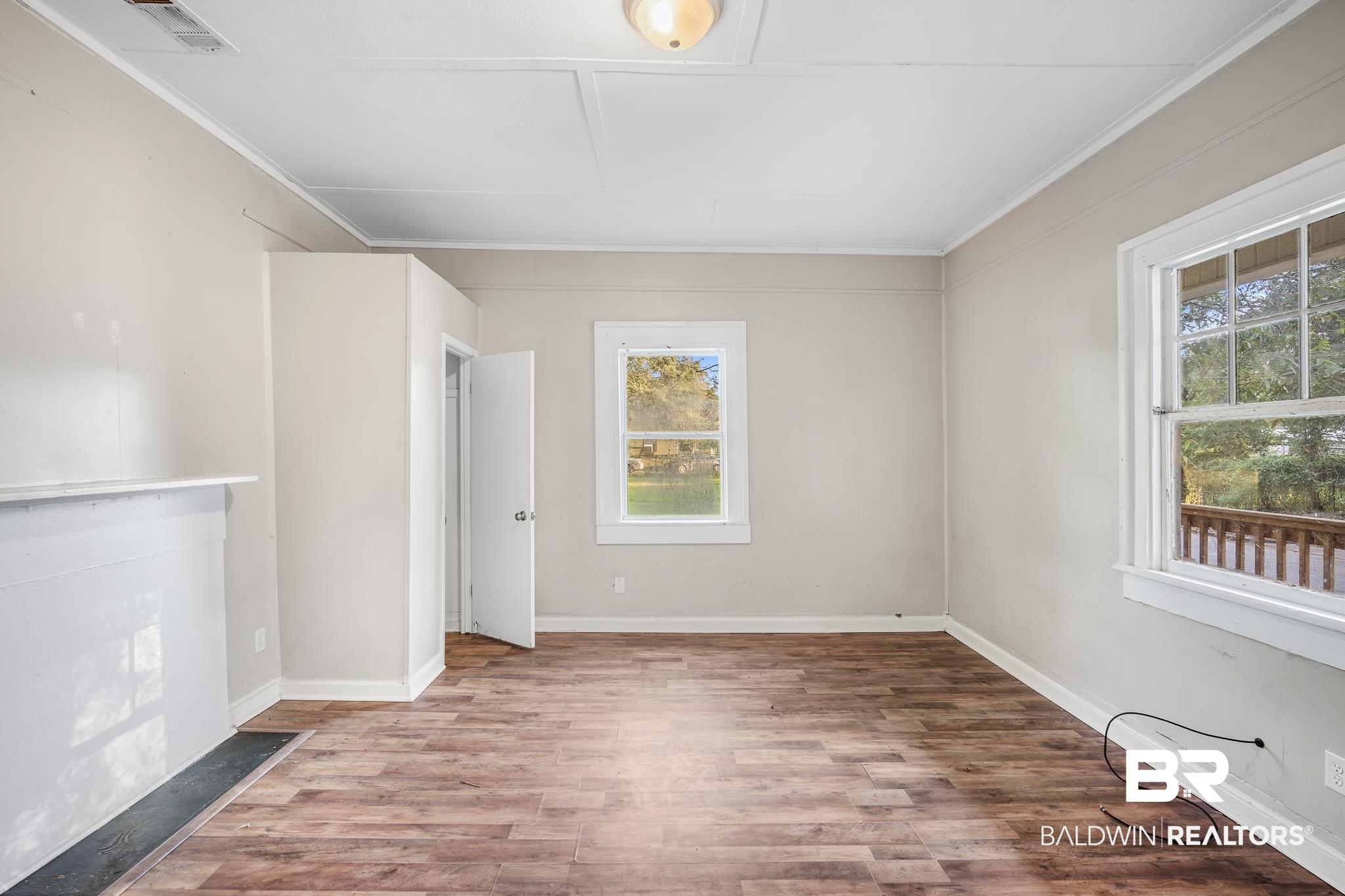 401 Gaston Street Mobile, AL 36603 - Photo 4 of 17 Unfurnished room featuring crown molding, light hardwood / wood-style flooring, and a wealth of natural light