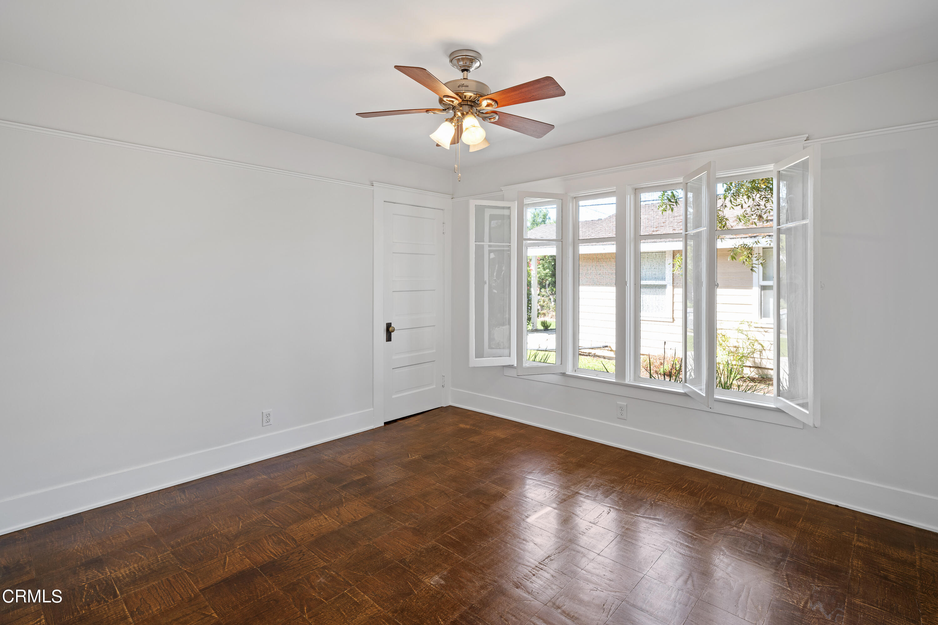 489 Miles Street Pasadena, CA 91106 - Photo 20 of 46 an empty room with wooden floor and ceiling fan