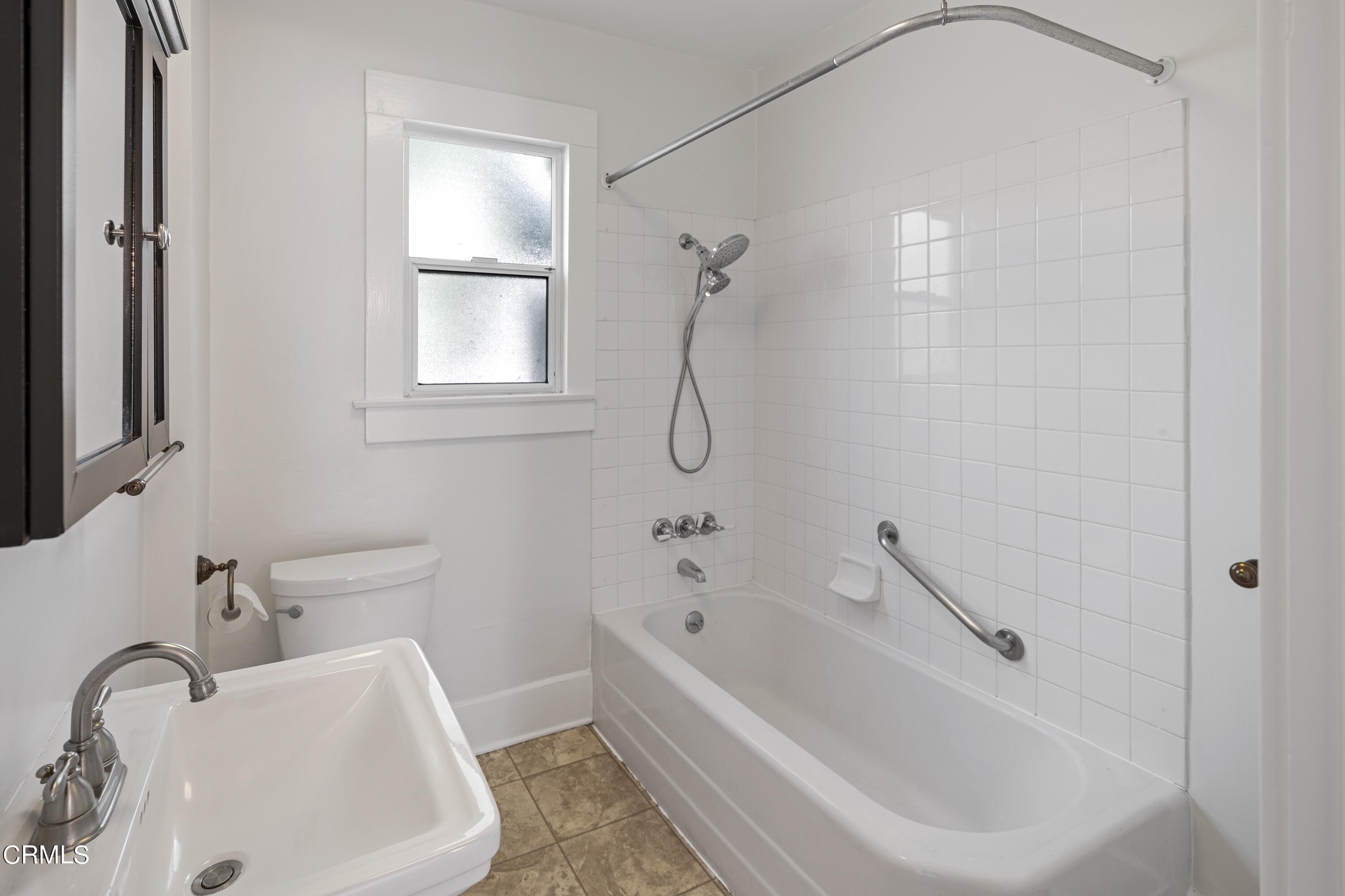 489 Miles Street Pasadena, CA 91106 - Photo 21 of 46 a white bath tub sitting next to a white sink and a toilet