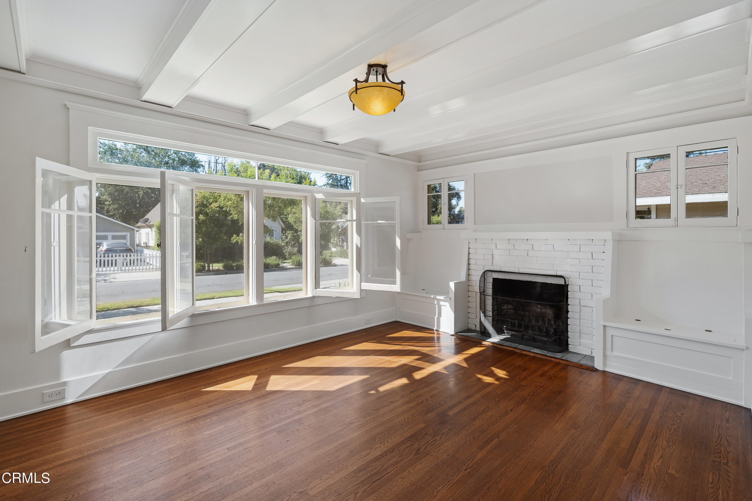 489 Miles Street Pasadena, CA 91106 - Photo 7 of 46 a view of empty room with wooden floor and fireplace