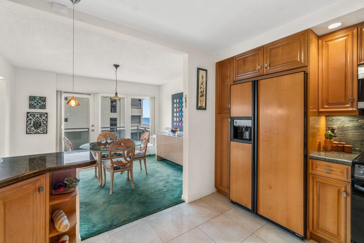 2066 North Ocean Boulevard, Unit 4NW Boca Raton, FL 33431 - Photo 12 of 31 a dining room with stainless steel appliances granite countertop furniture and a livingroom view