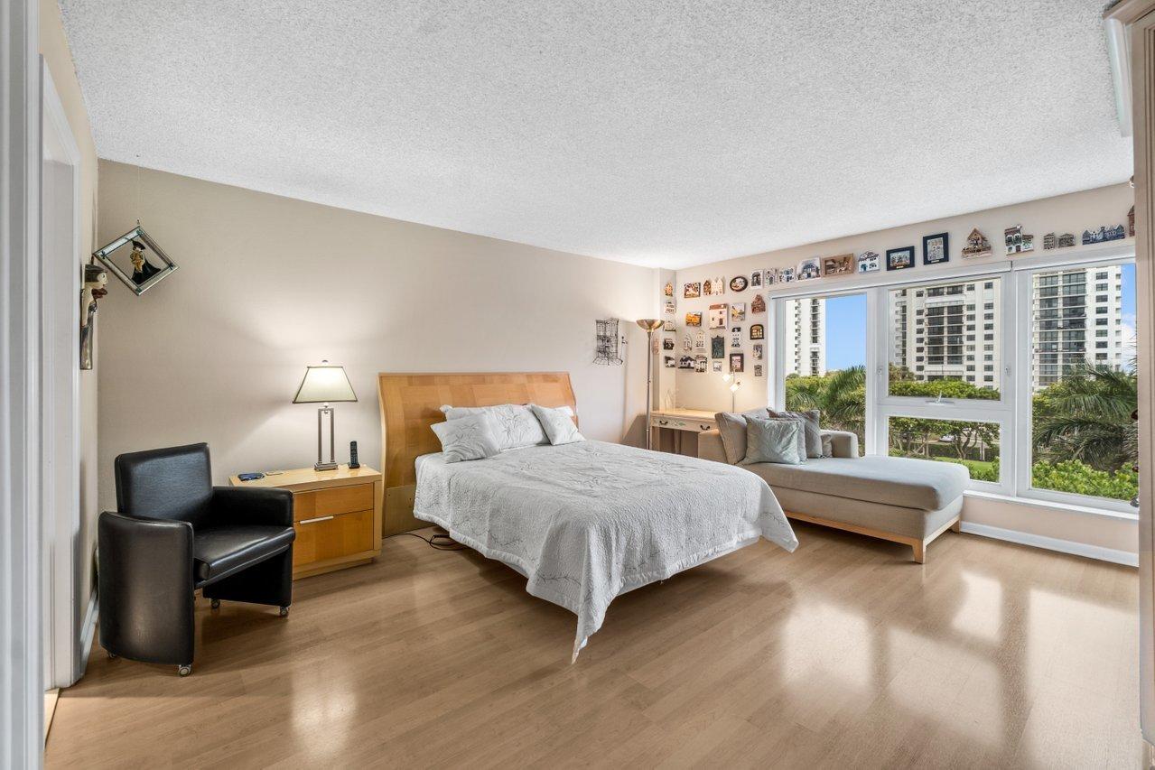 2066 North Ocean Boulevard, Unit 4NW Boca Raton, FL 33431 - Photo 16 of 31 a bedroom with a bed and a large window