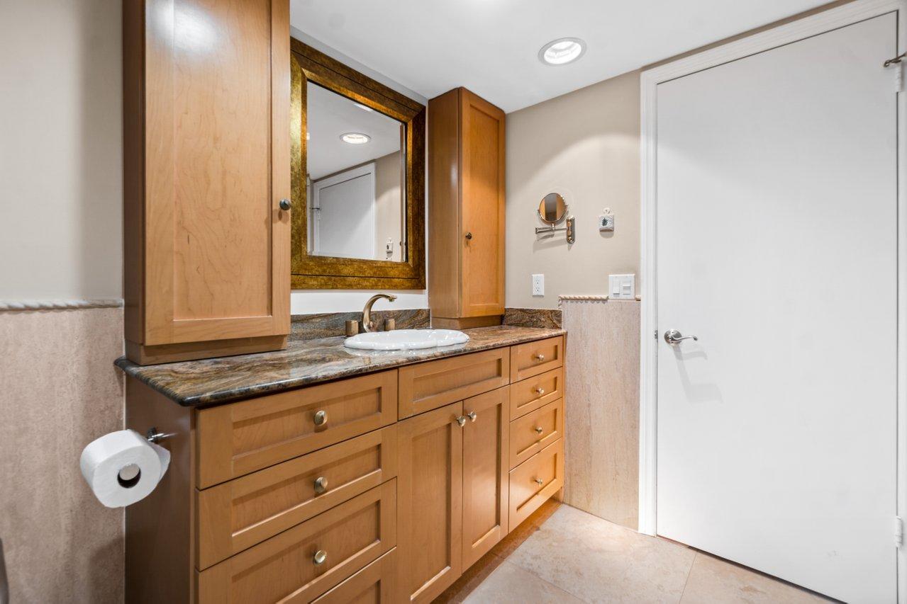 2066 North Ocean Boulevard, Unit 4NW Boca Raton, FL 33431 - Photo 18 of 31 a bathroom with a granite countertop sink and a mirror