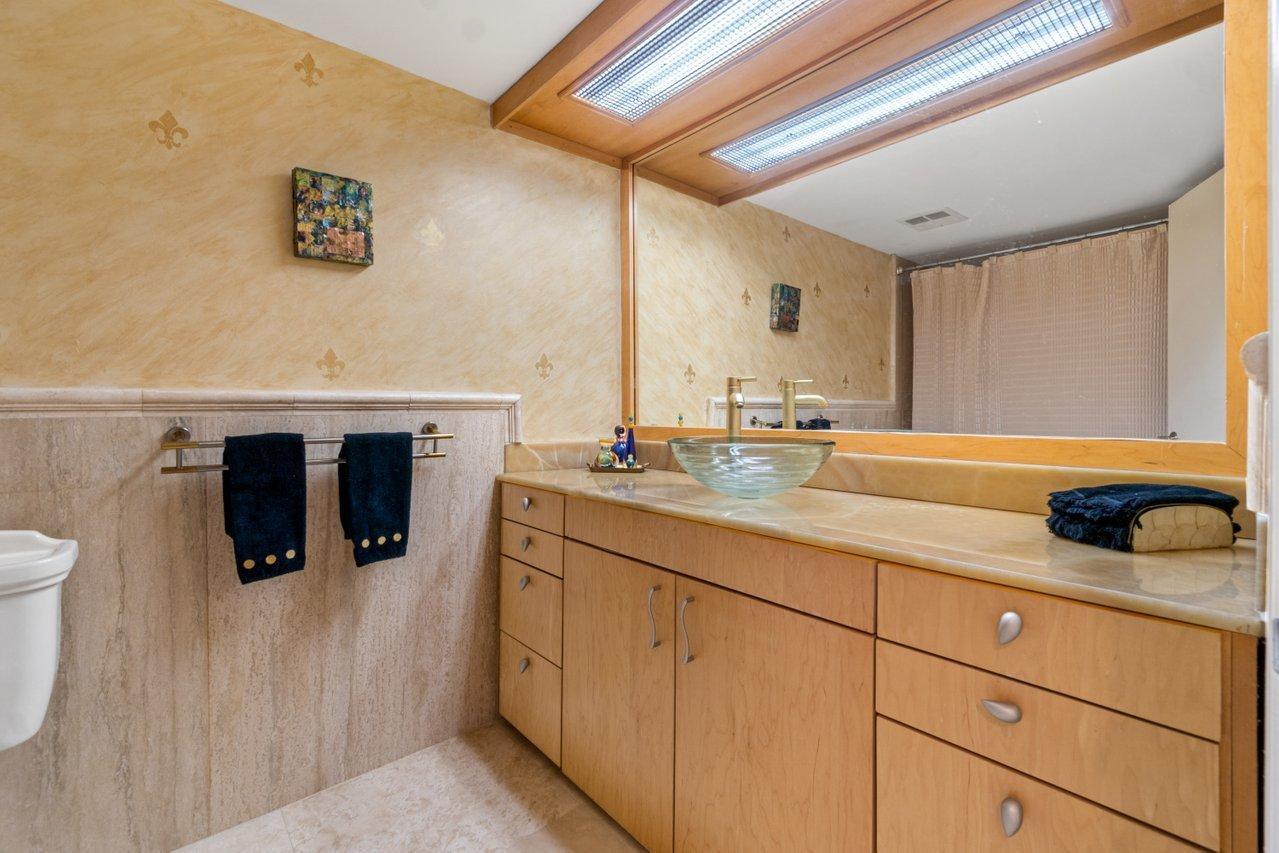 2066 North Ocean Boulevard, Unit 4NW Boca Raton, FL 33431 - Photo 21 of 31 a bathroom with a sink and mirror