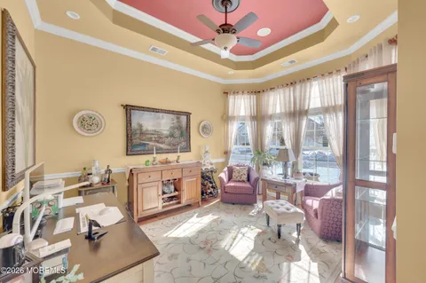 a living room with furniture a fireplace and a chandelier