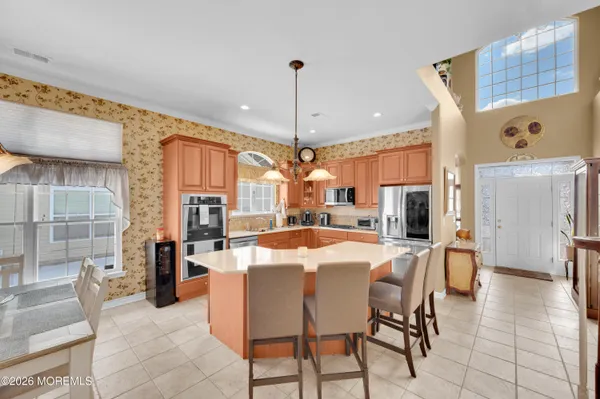 a kitchen with stainless steel appliances granite countertop a sink and a refrigerator