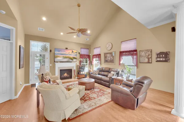 a living room with furniture a fireplace and a chandelier