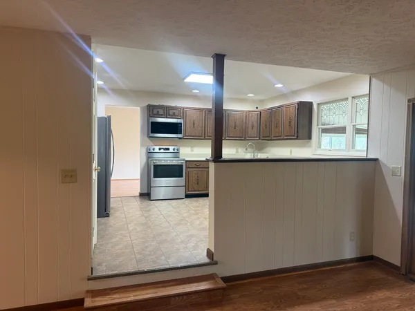 a kitchen with stainless steel appliances a stove sink and microwave