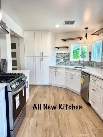 a kitchen with a stove a sink and a refrigerator