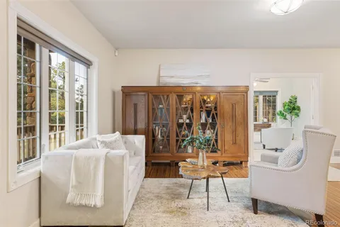 a living room with furniture and large windows