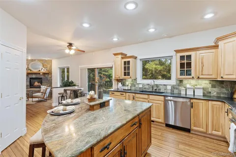 a kitchen with granite countertop a sink and cabinets
