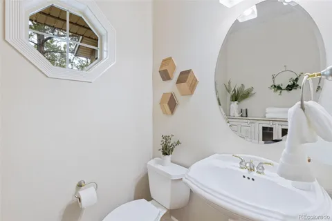 a bathroom with a sink mirror and toilet