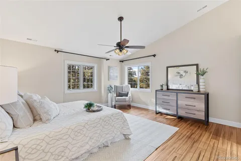 a bedroom with a bed and wooden floor