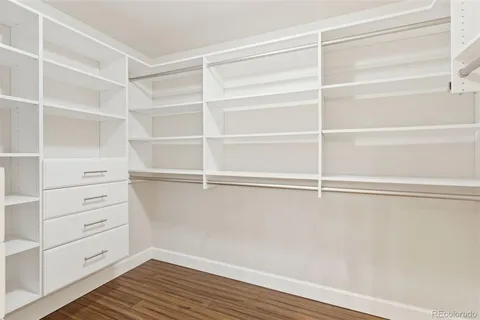 a view of walk in closet with empty racks