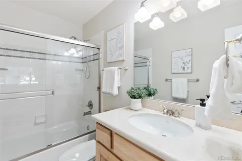 a bathroom with a sink a mirror and a shower
