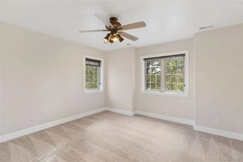 a view of room with window and ceiling fan