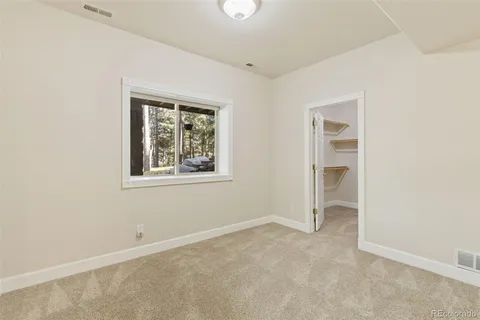 an empty room with windows and closet