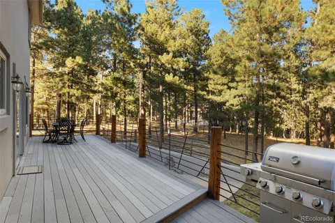 a front view of a house with a large tree