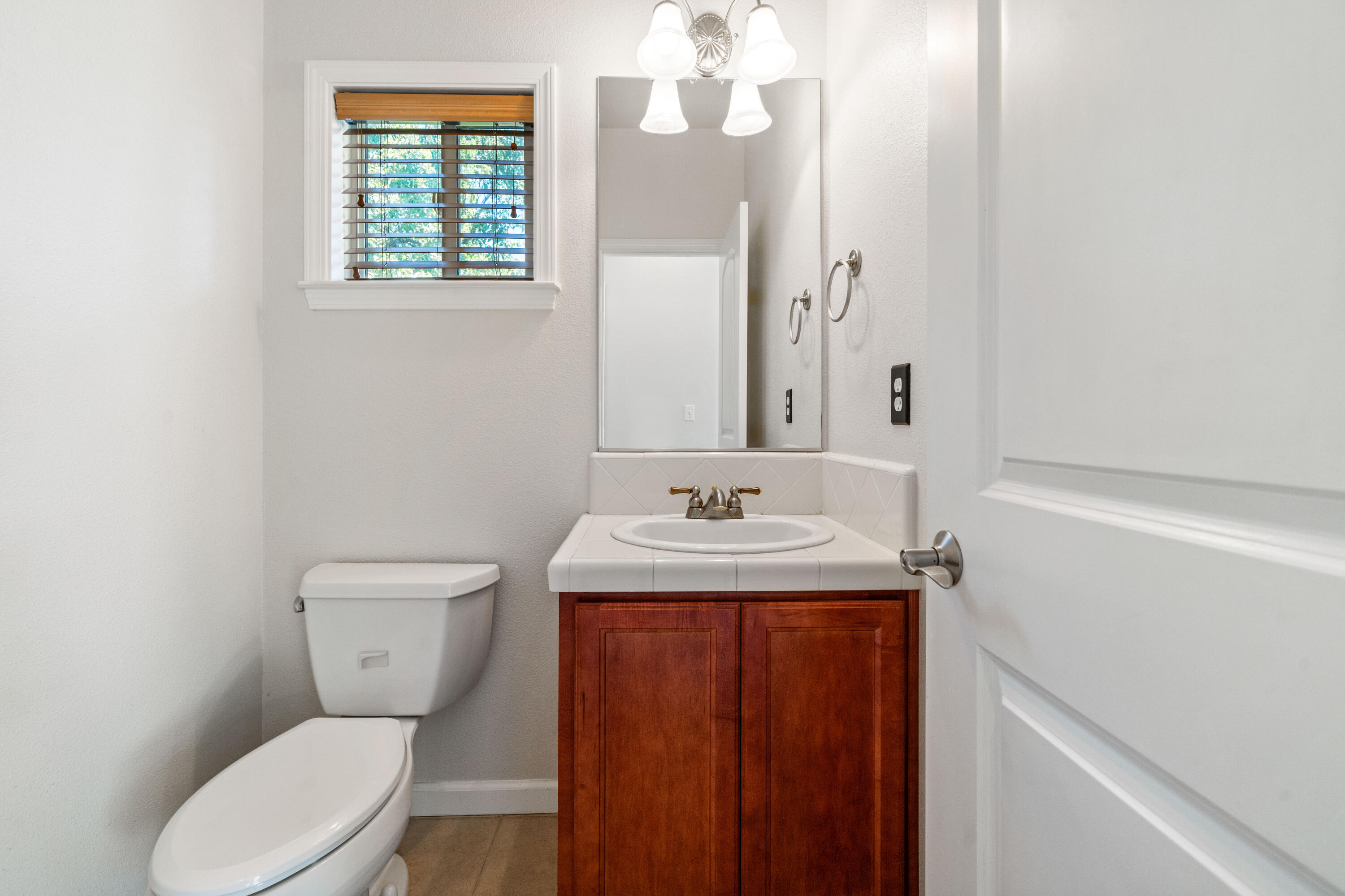 3180 Sinaloa Trail Redding, CA 96002 - Photo 9 of 22 a bathroom with a granite countertop toilet sink and mirror