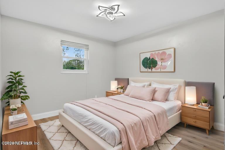 4725 Tango Lane West Jacksonville, FL 32210 - Photo 23 of 49 a bedroom with a bed and a painting on the wall