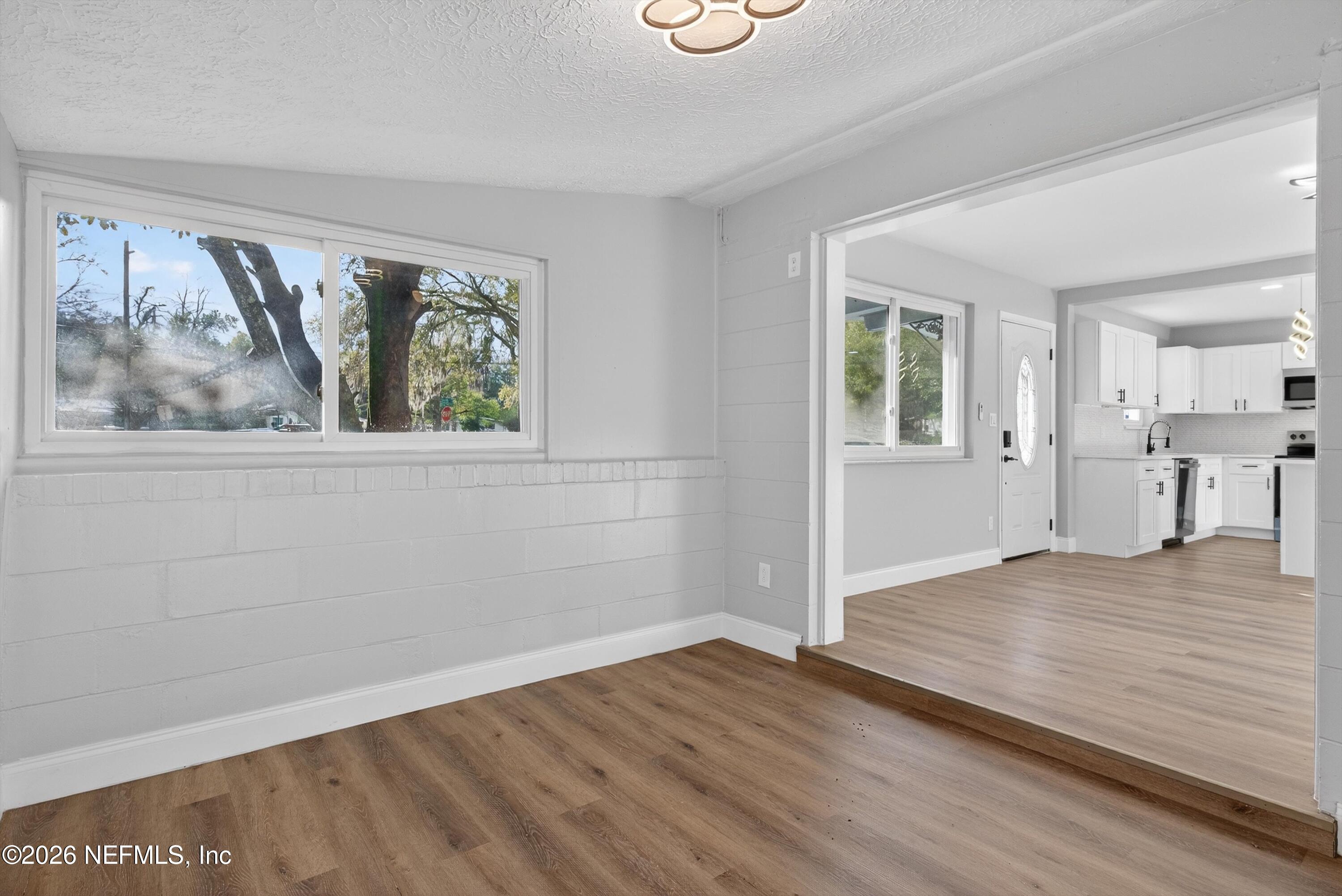 4725 Tango Lane West Jacksonville, FL 32210 - Photo 23 of 54 wooden floor in an empty room with a window