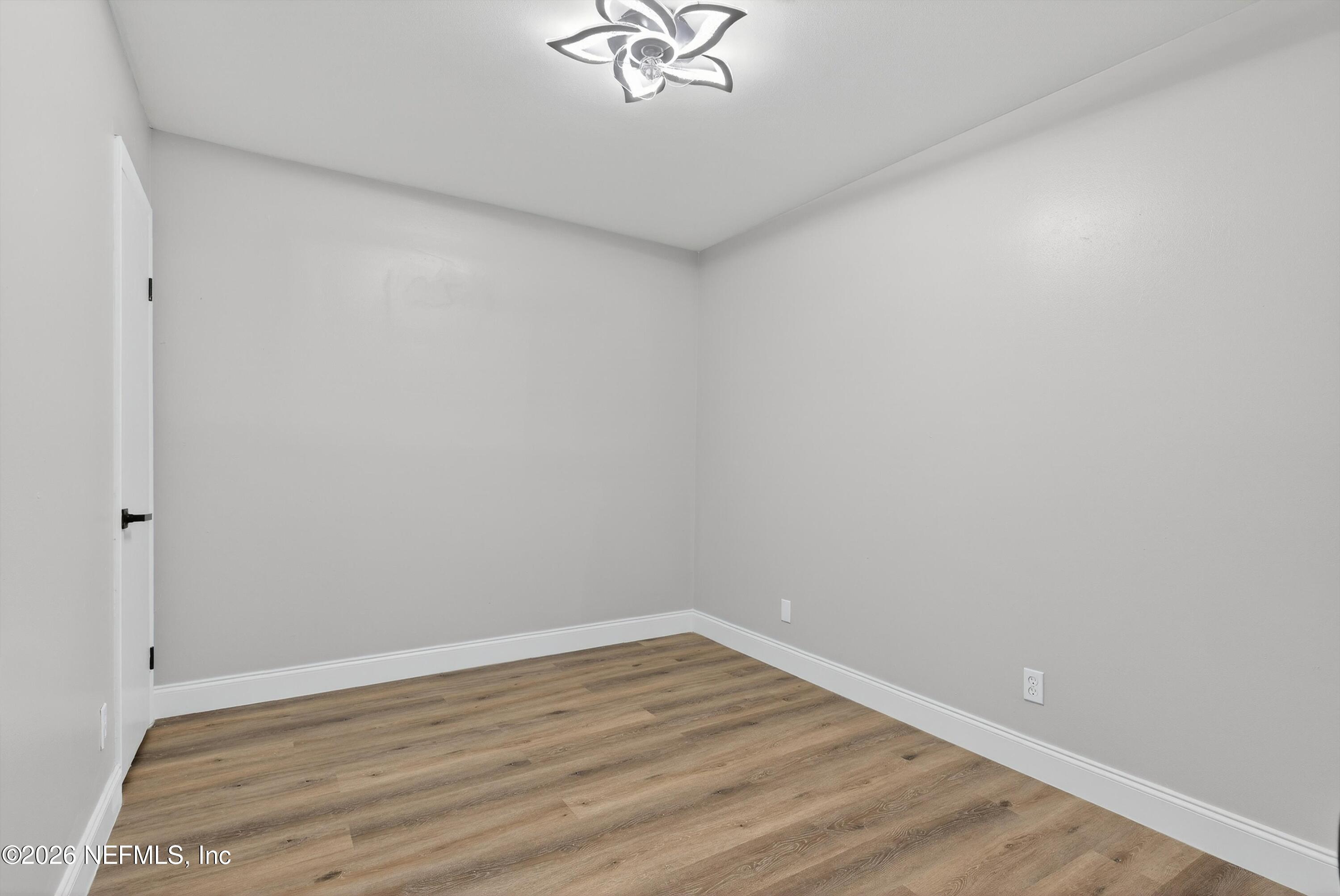 4725 Tango Lane West Jacksonville, FL 32210 - Photo 31 of 54 a view of a room with wooden floor and a ceiling fan