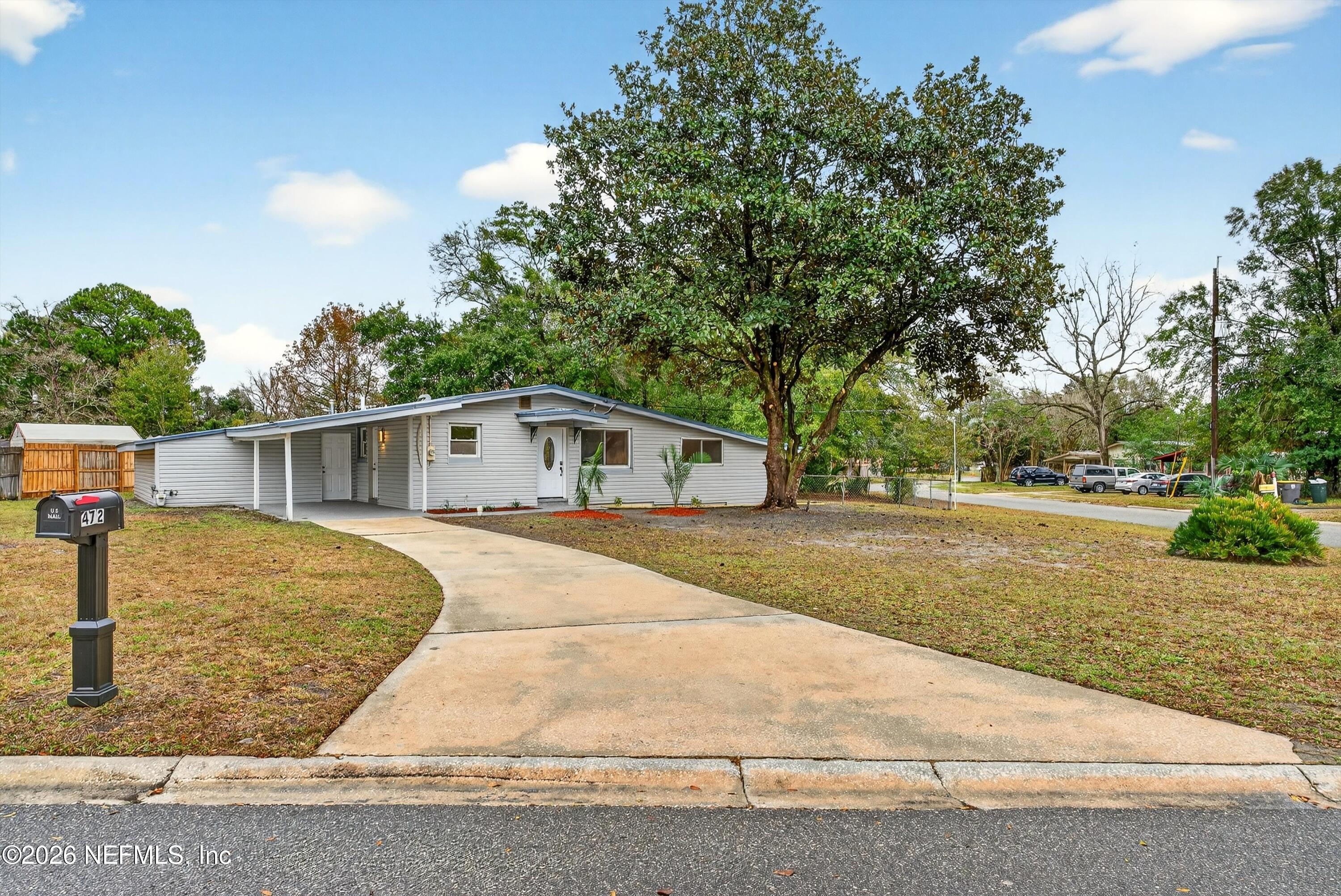4725 Tango Lane West Jacksonville, FL 32210 - Photo 4 of 54 a front view of a house with a yard