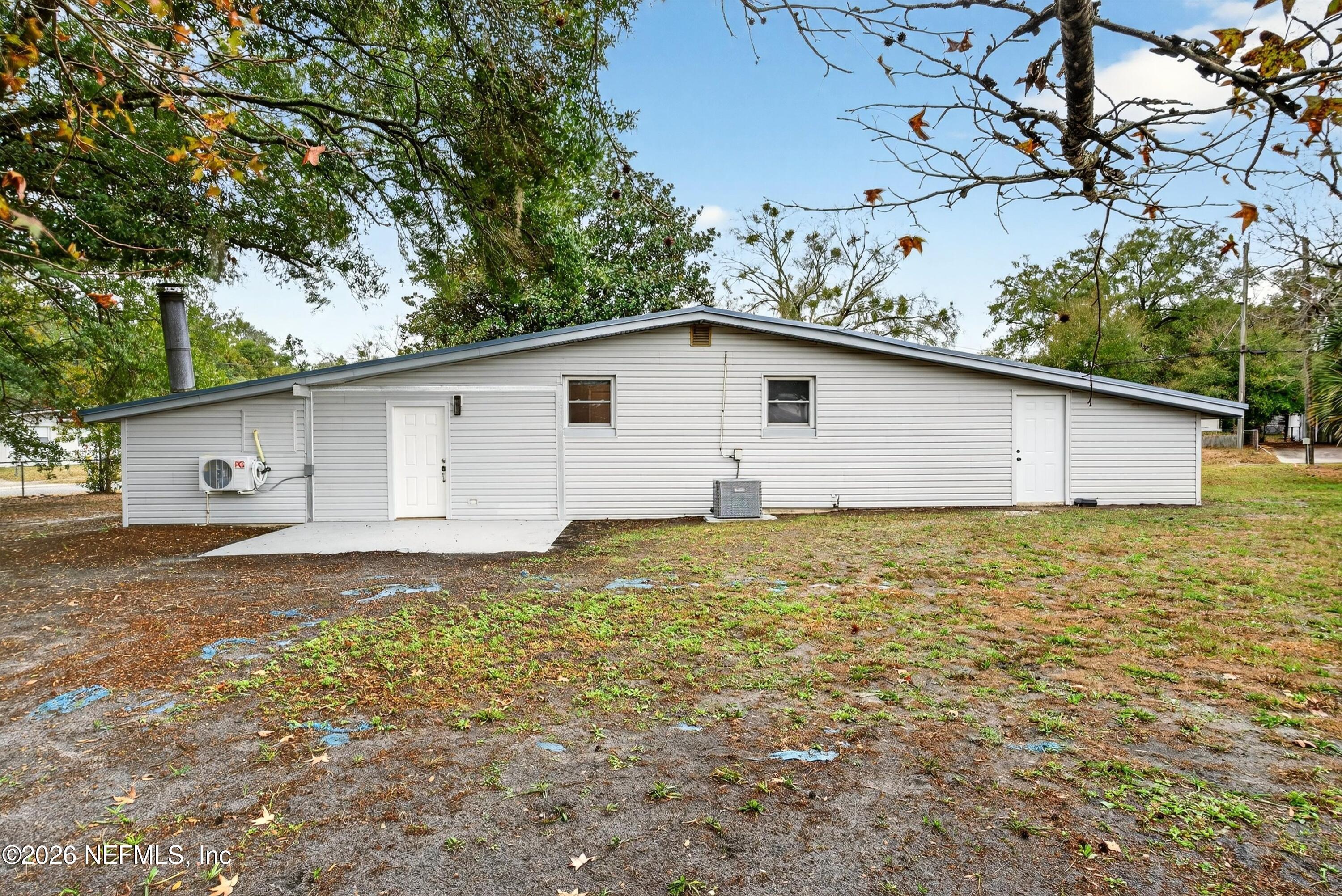 4725 Tango Lane West Jacksonville, FL 32210 - Photo 48 of 54 a view of a backyard with a large tree