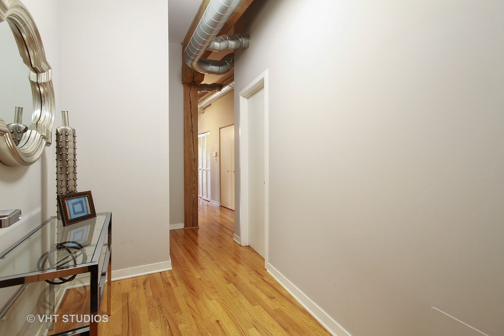 1344 West Madison Street, Unit 201 Chicago, IL 60607 - Photo 2 of 10 a view of a room with wooden floor and a bathroom