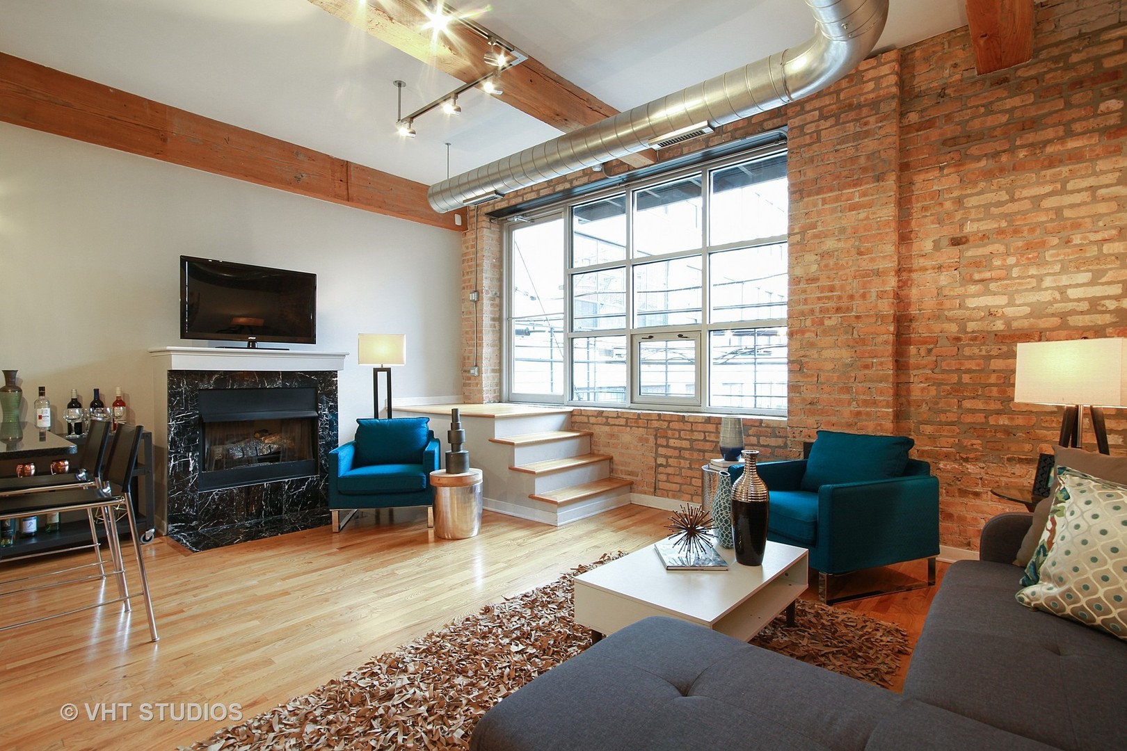 1344 West Madison Street, Unit 201 Chicago, IL 60607 - Photo 3 of 10 a living room with furniture fireplace and flat screen tv
