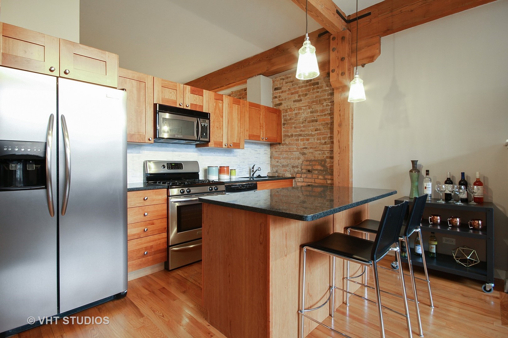 1344 West Madison Street, Unit 201 Chicago, IL 60607 - Photo 7 of 10 a kitchen with stainless steel appliances granite countertop a refrigerator and a stove top oven
