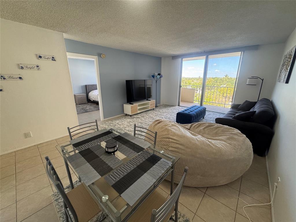 2000 South Ocean Boulevard, Unit 5P Lauderdale-by-the-Sea, FL 33062 - Photo 8 of 34 a bedroom with a bed and a flat screen tv