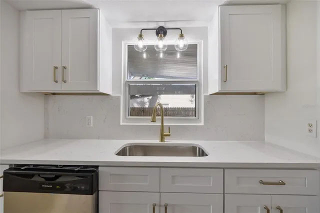 a kitchen with a sink and cabinets