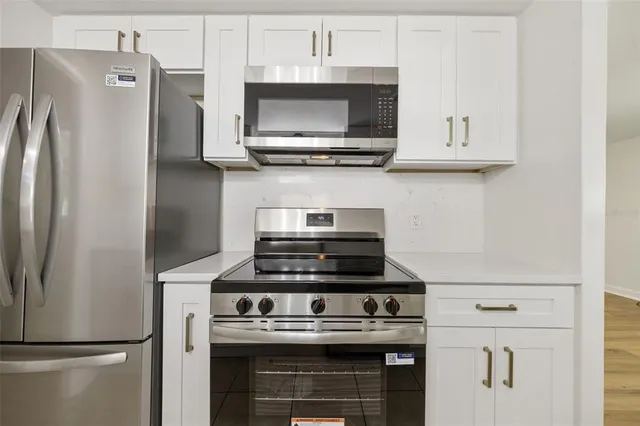 a stove top oven sitting inside of a kitchen