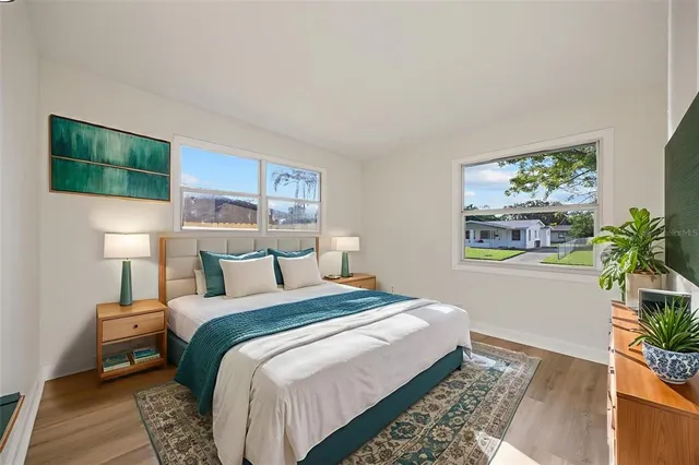 a bedroom with a bed and a potted plant