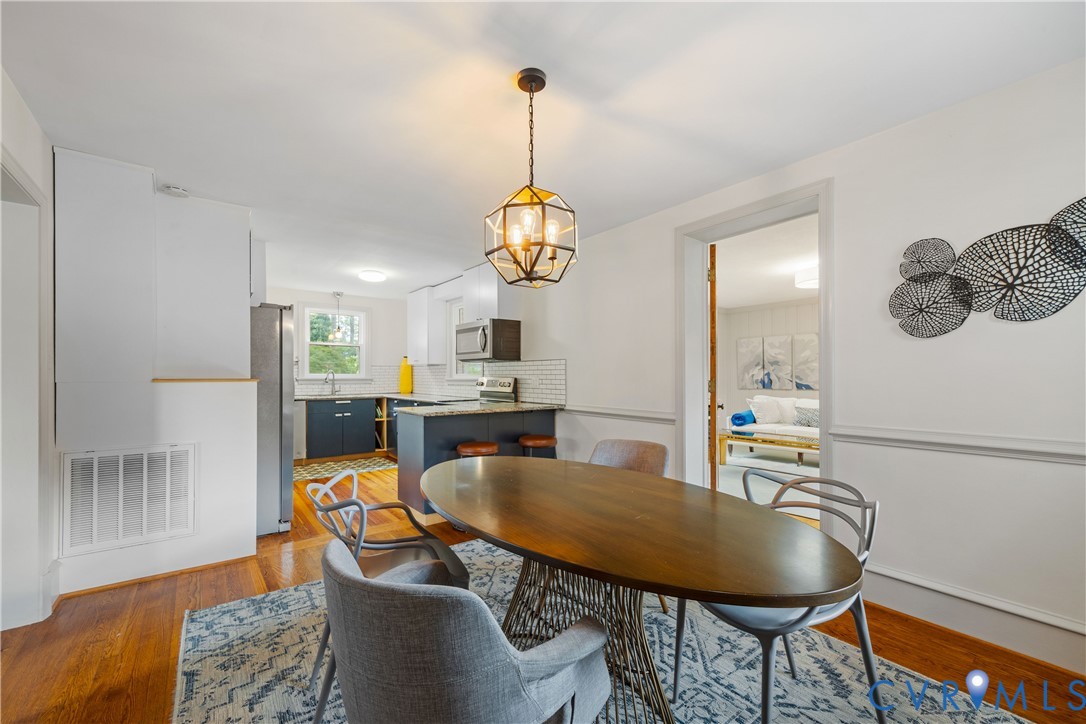 901 Bevridge Road Richmond, VA 23226 - Photo 15 of 43 a dining room with furniture a chandelier and wooden floor