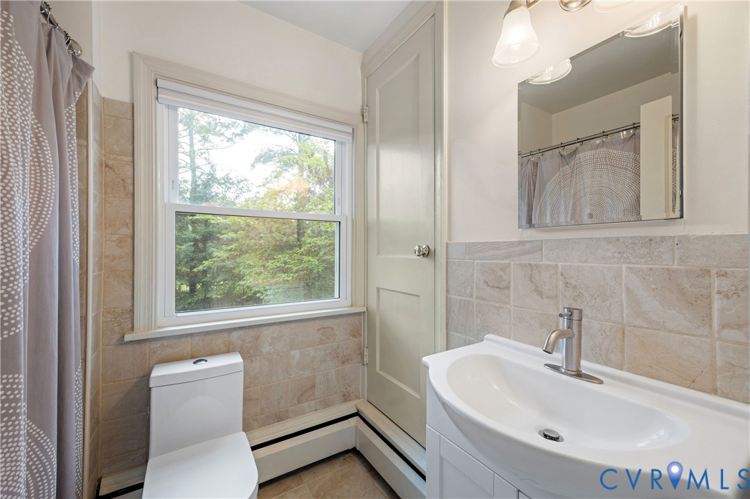 901 Bevridge Road Richmond, VA 23226 - Photo 28 of 43 a bathroom with a sink a toilet and a mirror